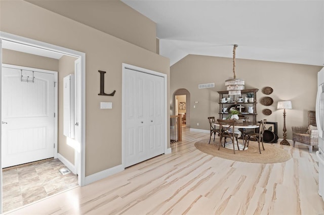 dining room featuring lofted ceiling and light hardwood / wood-style floors