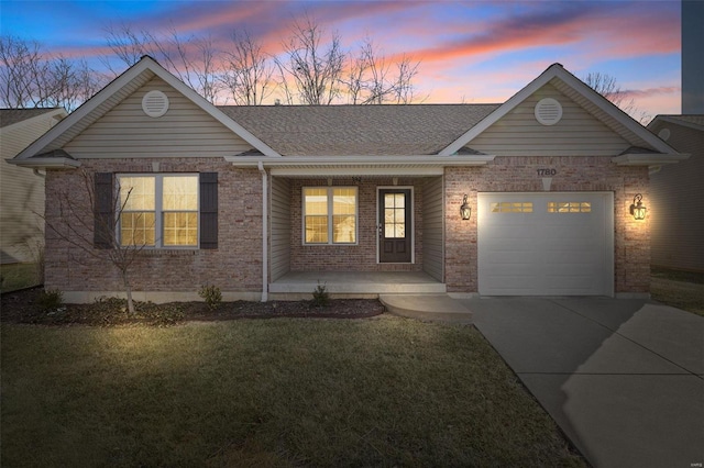 ranch-style house featuring a yard, a garage, and covered porch