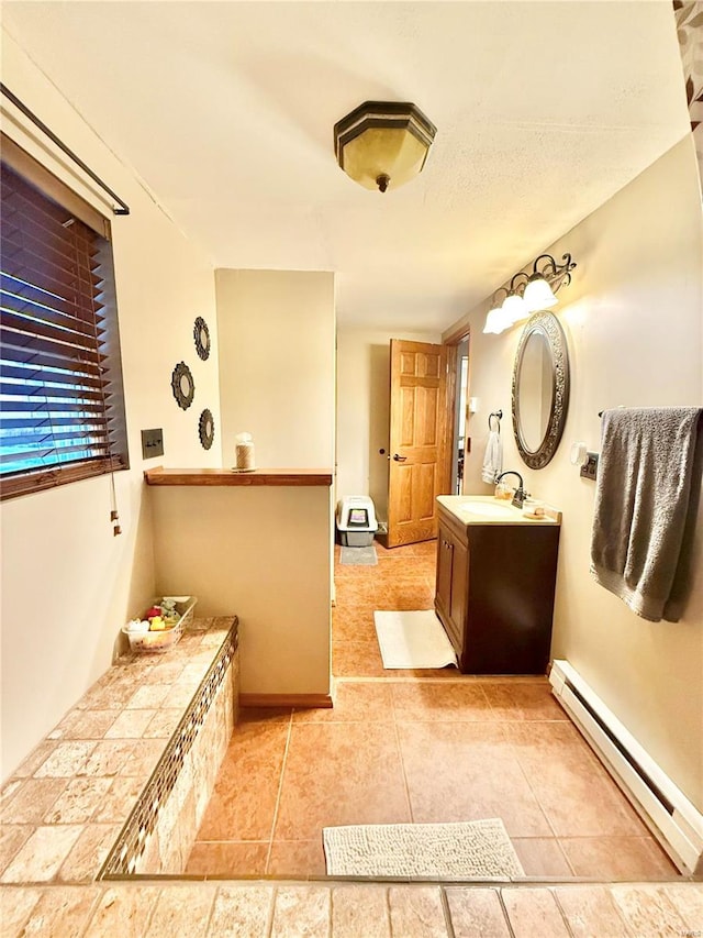 bathroom with vanity, a baseboard radiator, and tile patterned floors