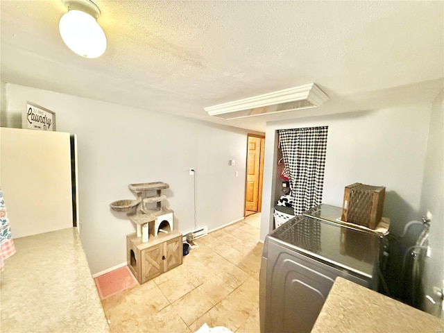 kitchen featuring washer / clothes dryer and a textured ceiling