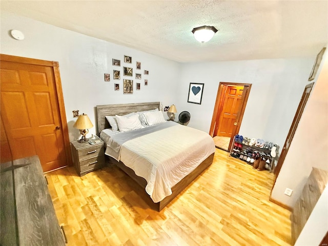 bedroom featuring a textured ceiling and hardwood / wood-style flooring