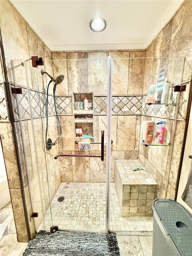 bathroom with ornamental molding and an enclosed shower