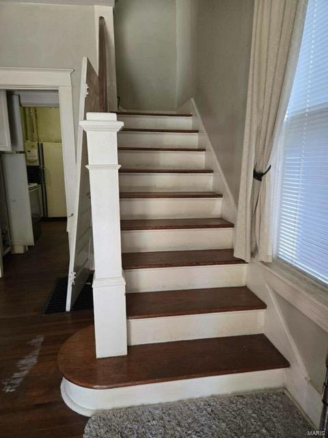 stairs with hardwood / wood-style flooring