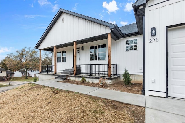 view of front facade with a garage and a porch