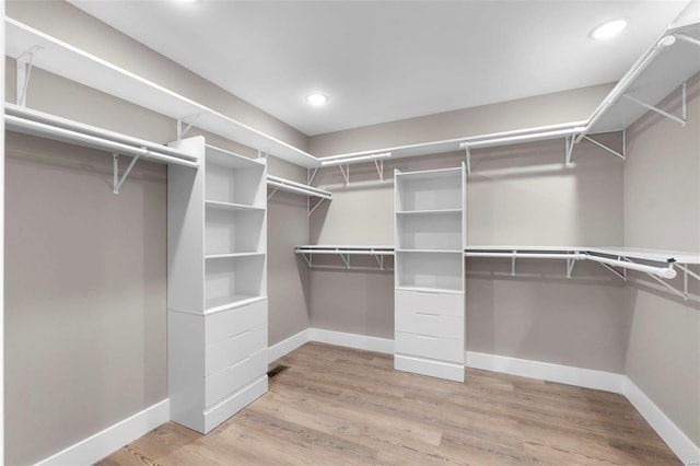 spacious closet featuring hardwood / wood-style floors