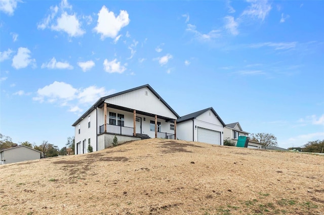 view of front of property with covered porch and a garage