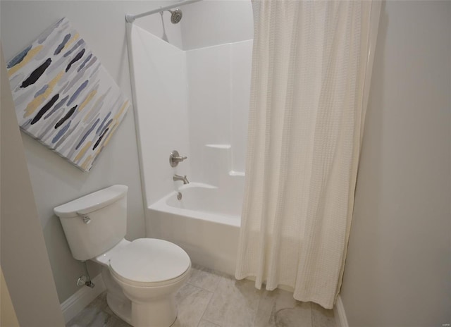 bathroom featuring shower / tub combo and toilet