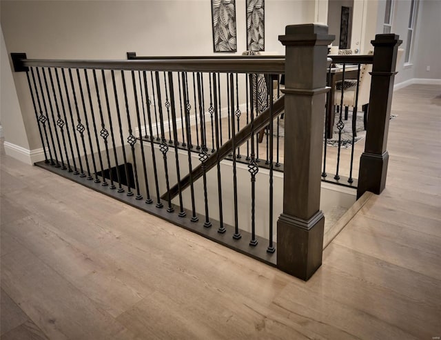 stairway with hardwood / wood-style flooring