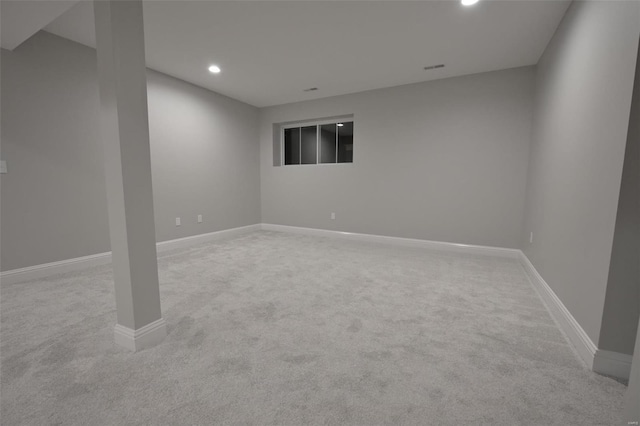 basement featuring light carpet