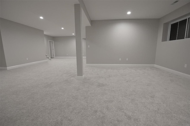 basement featuring light carpet