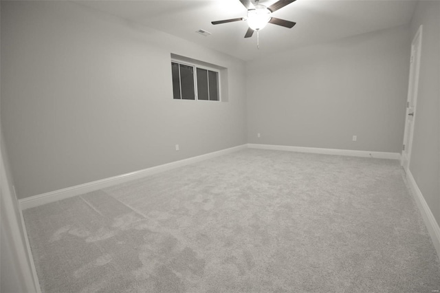 carpeted empty room featuring ceiling fan