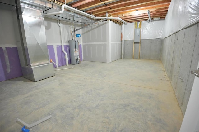 basement featuring heating unit, gas water heater, and electric panel