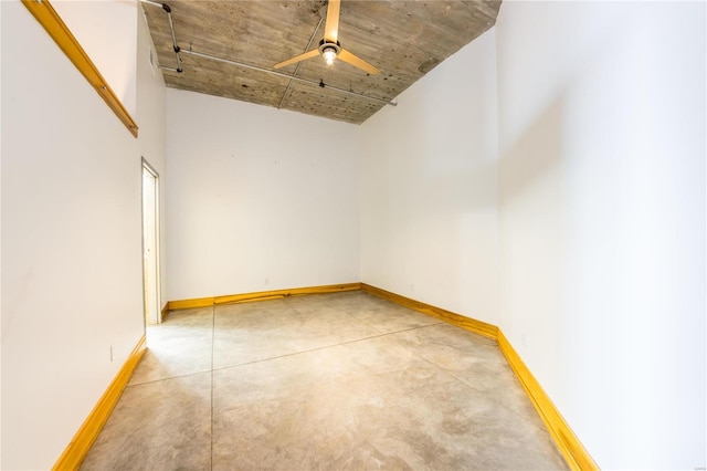 unfurnished room featuring a high ceiling and ceiling fan