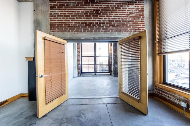 interior space featuring brick wall