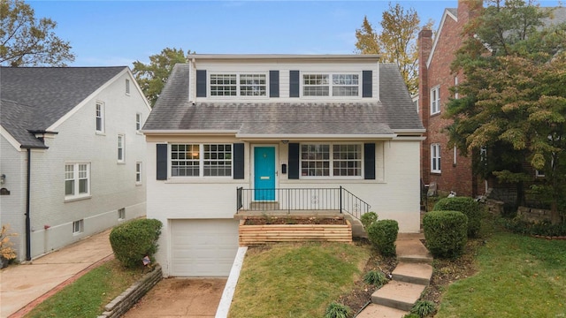 view of front of property with a garage, covered porch, and a front lawn