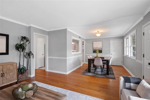 dining space with light hardwood / wood-style floors and crown molding