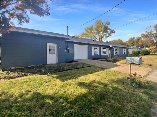 back of house with a garage and a lawn