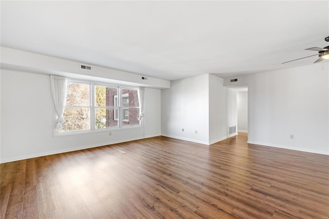 unfurnished room with dark hardwood / wood-style floors and ceiling fan