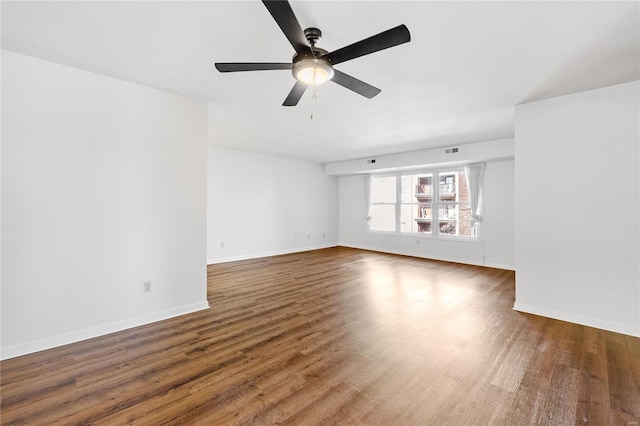 unfurnished room featuring ceiling fan and dark wood-type flooring