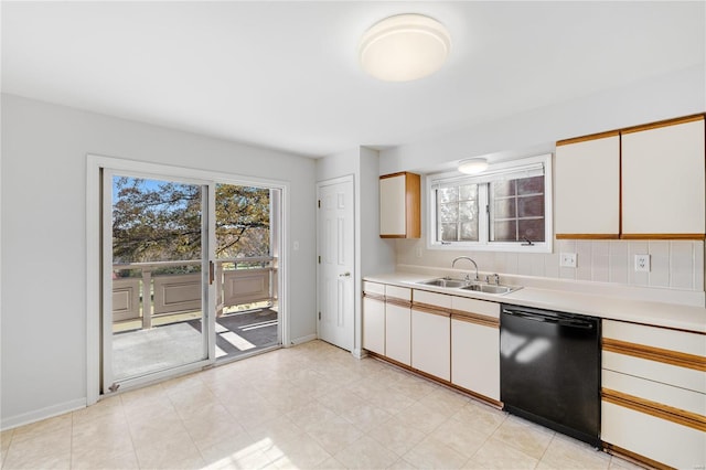 kitchen with backsplash, dishwasher, white cabinetry, and sink