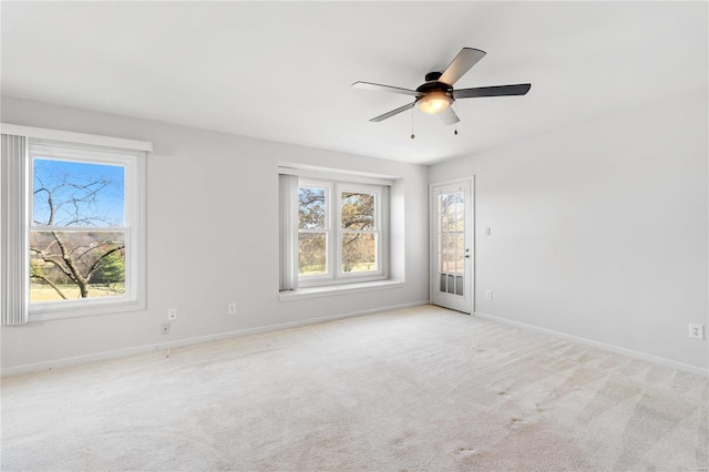 empty room featuring light carpet and ceiling fan