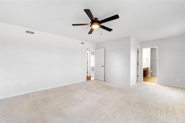 carpeted spare room with ceiling fan