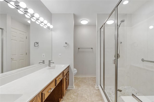 bathroom featuring tile patterned floors, vanity, toilet, and an enclosed shower