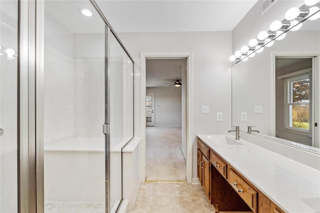 bathroom with ceiling fan, vanity, and a shower with shower door