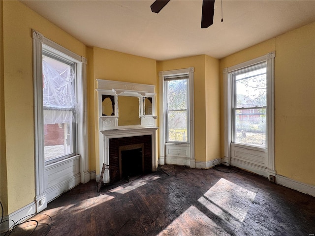 unfurnished living room featuring dark hardwood / wood-style floors and ceiling fan