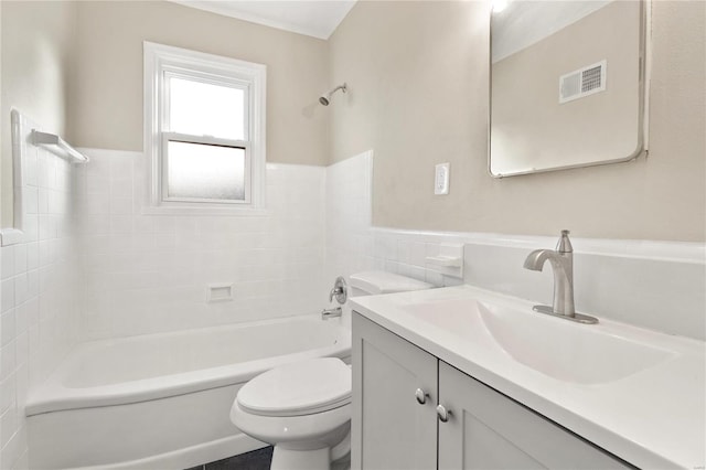 full bathroom with tile walls, washtub / shower combination, vanity, and toilet