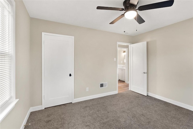 unfurnished bedroom featuring ceiling fan and carpet floors