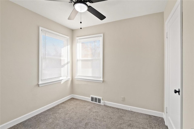 empty room with ceiling fan and carpet floors