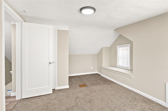 additional living space with carpet floors and lofted ceiling