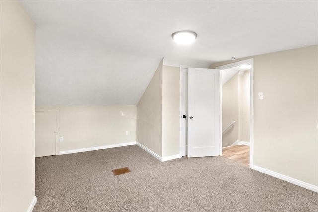 additional living space with lofted ceiling and carpet floors