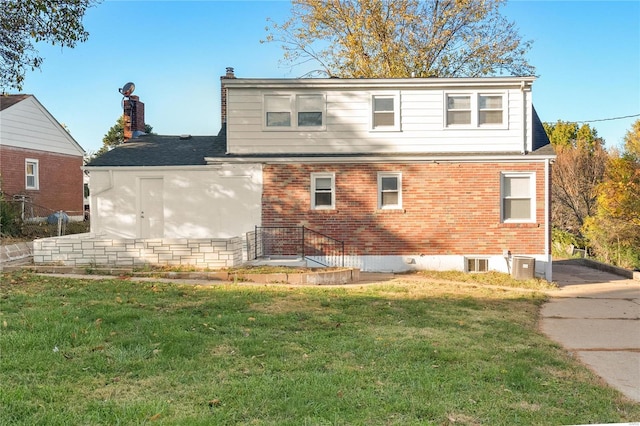 back of house featuring central AC and a yard