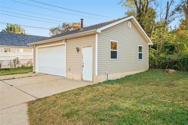 garage featuring a lawn