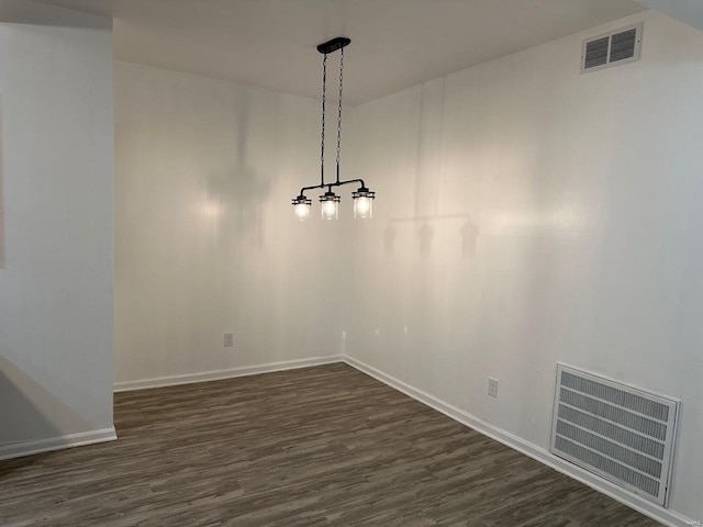 unfurnished dining area featuring dark wood-type flooring