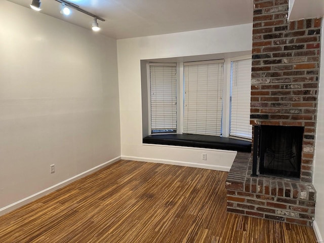 unfurnished living room with a fireplace and dark hardwood / wood-style flooring