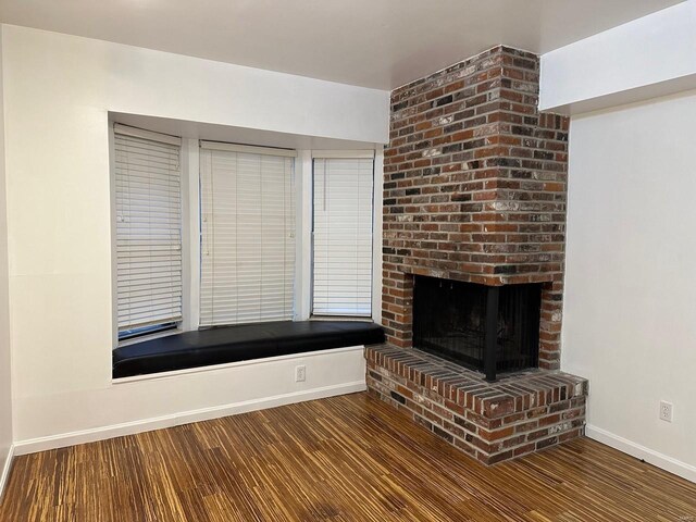 unfurnished living room with hardwood / wood-style flooring and a fireplace