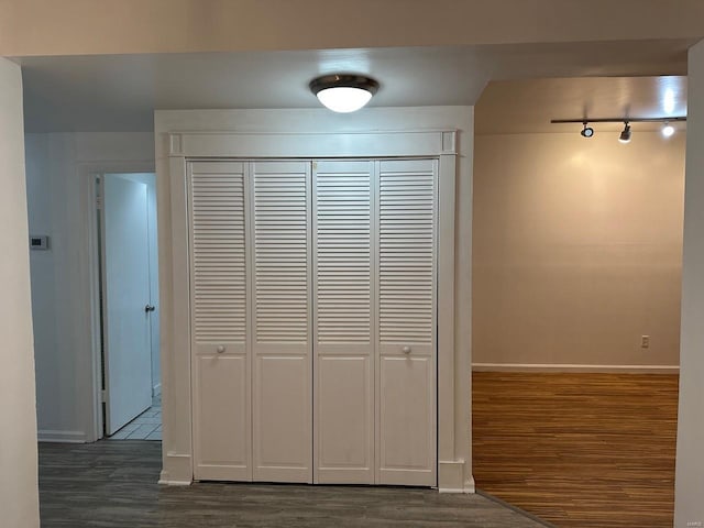 interior space featuring track lighting and dark hardwood / wood-style floors