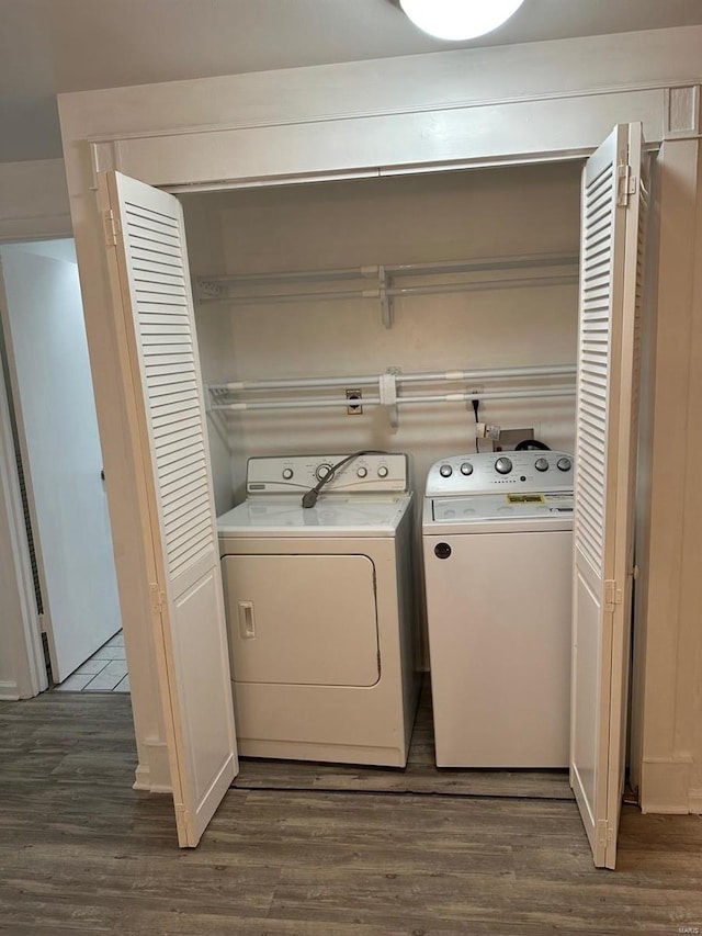 clothes washing area featuring independent washer and dryer and dark wood-type flooring