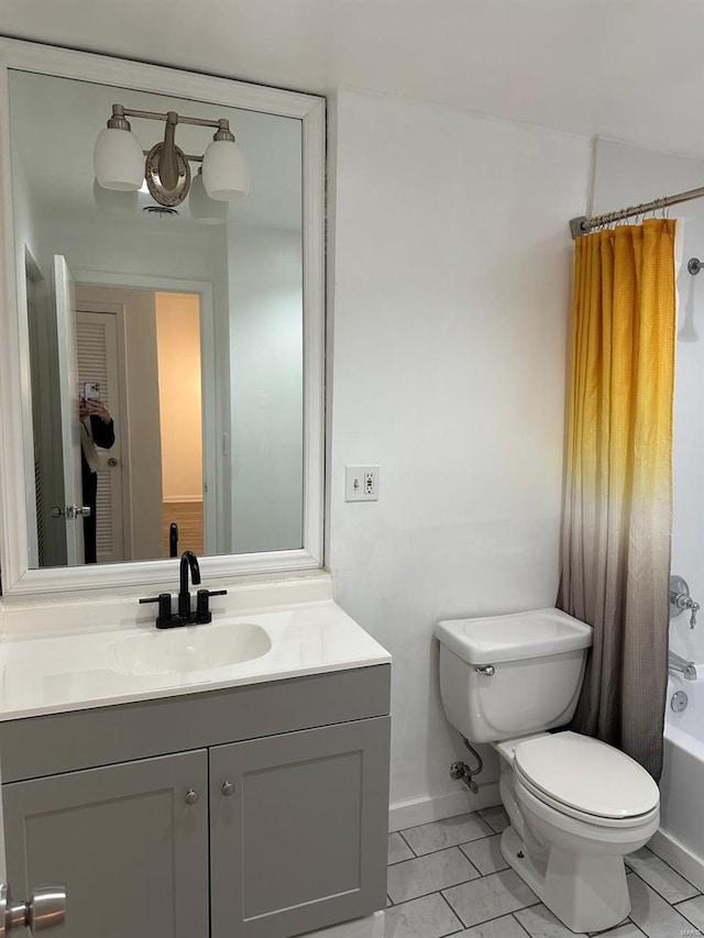 full bathroom featuring vanity, shower / bath combo with shower curtain, toilet, and tile patterned flooring