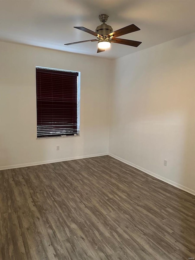 empty room featuring ceiling fan and dark hardwood / wood-style flooring