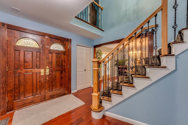 foyer with hardwood / wood-style flooring and a notable chandelier