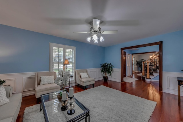 living room with dark hardwood / wood-style flooring and ceiling fan