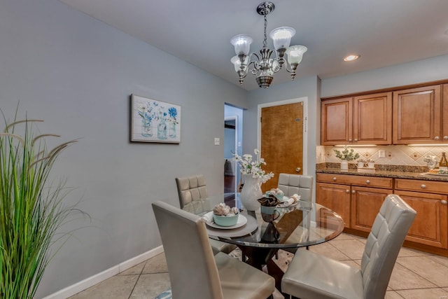 dining area featuring light tile patterned floors and a notable chandelier