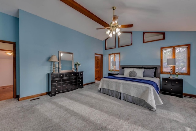 carpeted bedroom with ceiling fan and high vaulted ceiling