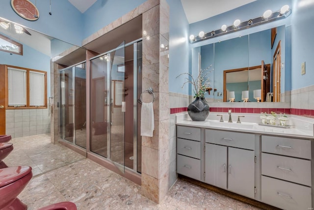 bathroom featuring vanity, lofted ceiling, and a shower with shower door