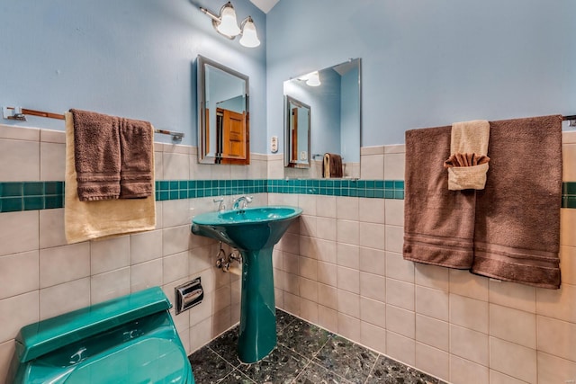 bathroom with tile walls