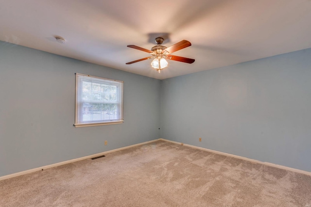 carpeted spare room with ceiling fan